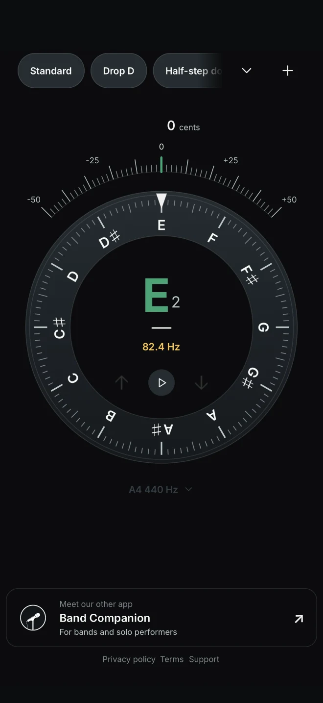Tuner’s circular pitch display showing an E2 note in tune, with a centered precision indicator